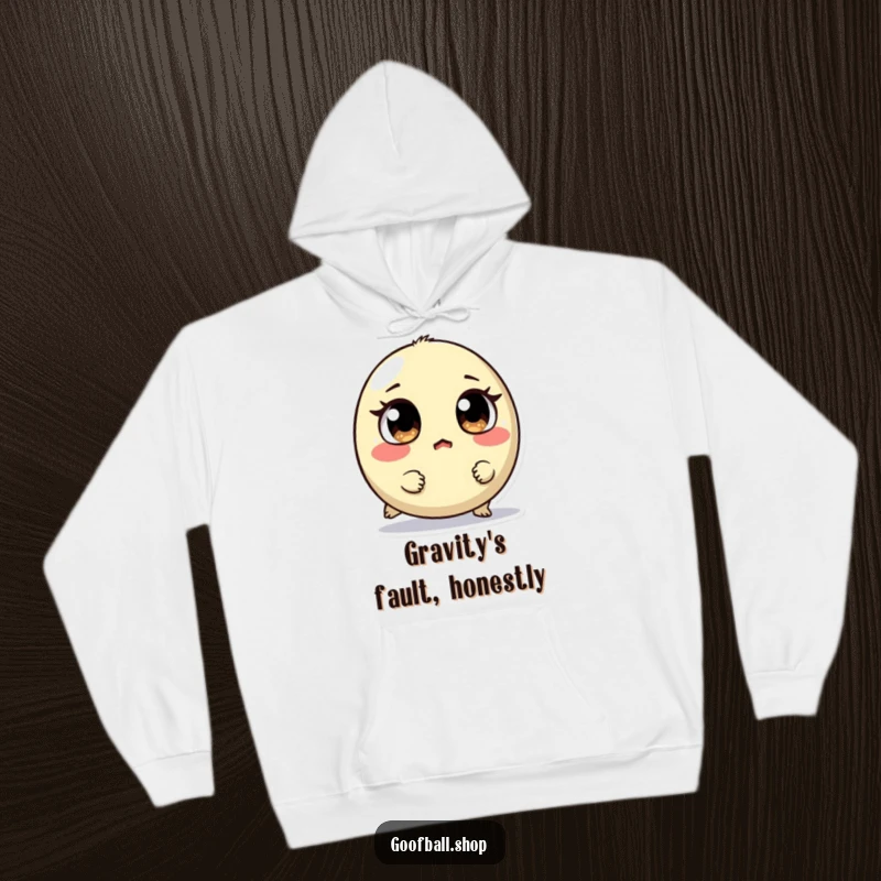 Funny hoodie showing a small, round creature with mismatched eyes tripping, looking surprised, perfect for cozy, humorous relaxation.